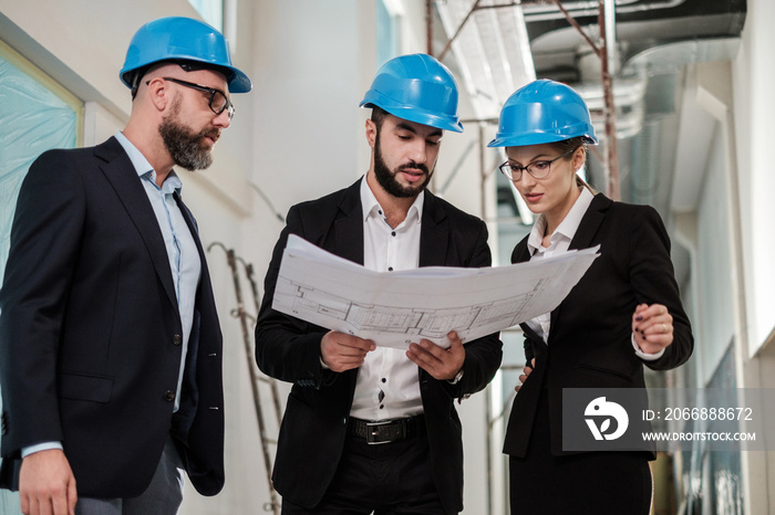 Engineers in hardhats have conversation