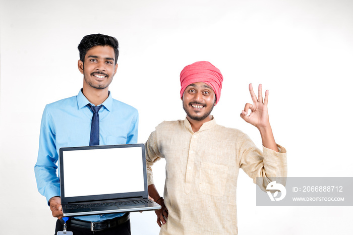Young indian officer showing laptop screen with farmer on white background.