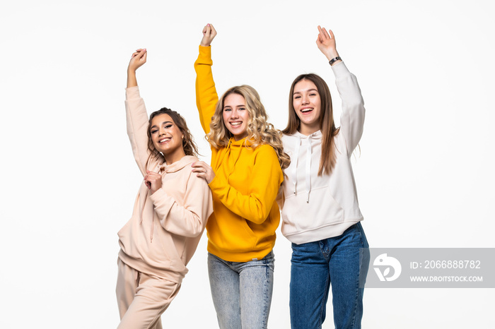 Young three young women dancing over white background