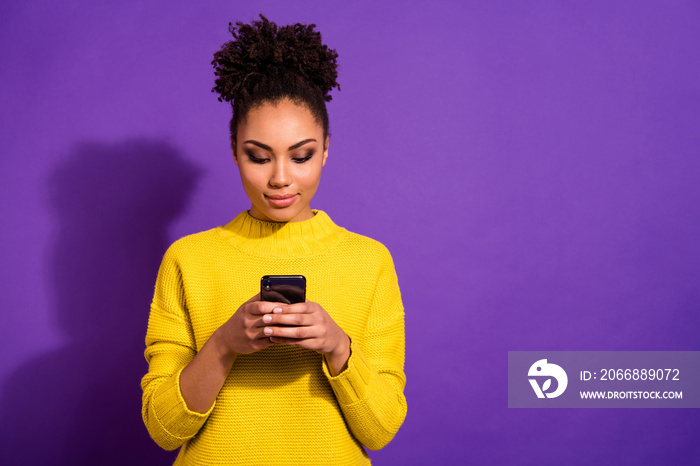 Portrait of her she nice attractive lovely winsome sweet gorgeous focused wavy-haired girl holding in hands device gadget isolated over bright vivid shine violet background