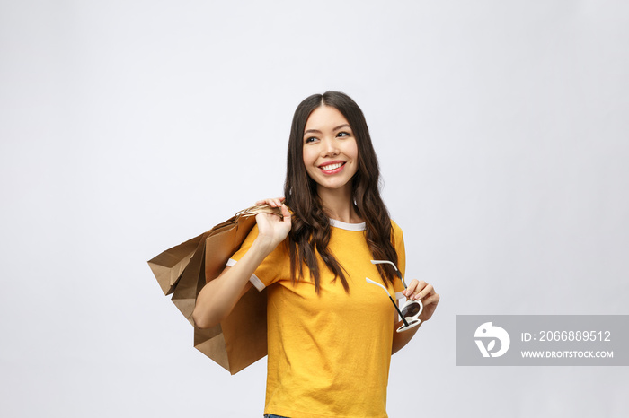 Beautiful Attractive Asian Woman smile and holding shopping bags feeling so happiness and enjoy with black Friday sale in Shopping mall,isolated on white background,Shopping Concept.