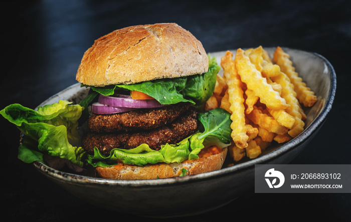 köstlicher vegan Burger mit Fleischersatz und knusprigen Pommes frites