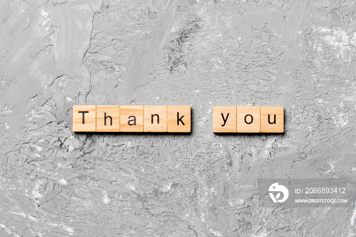 thank you word written on wood block. thank you text on table, concept