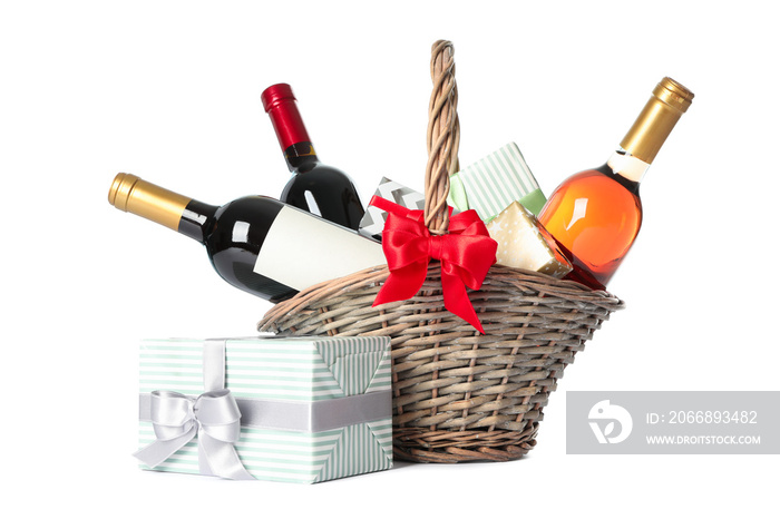 Wicker basket with bottles of wine and presents isolated on white background