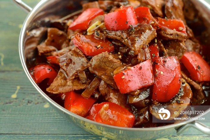 Beef black pepper steak - stir-fried tender beef with red bell peppers and mushrooms.