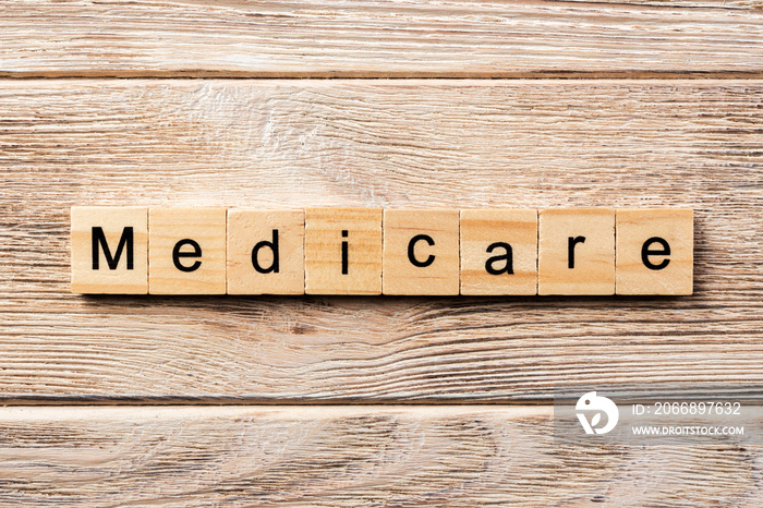 medicare word written on wood block. medicare text on table, concept