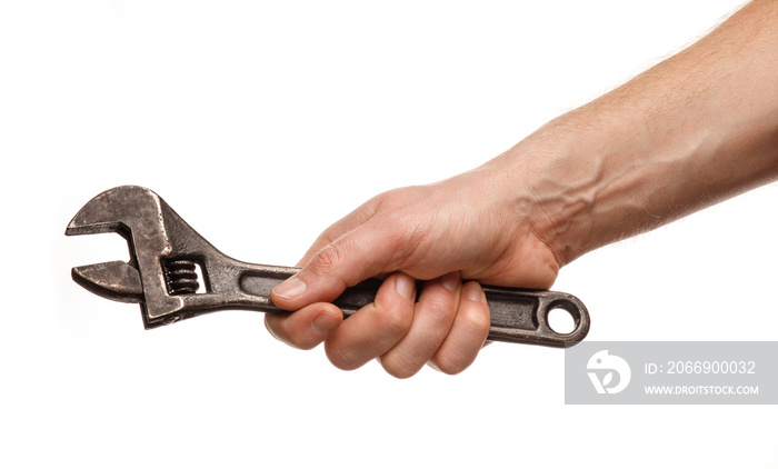 Adjustable wrench in the hands of a man on a white background isolate and close-up