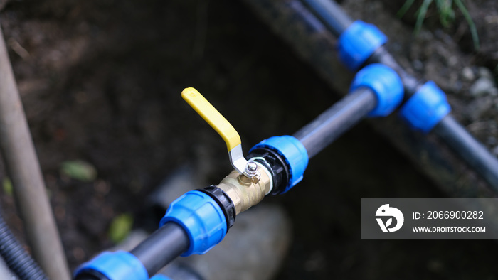 Water valve connected to PVC pipe closeup