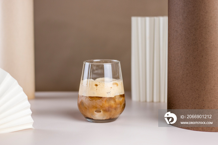 Iced coffee. Coffee cold brew drink cocktail with ice cube on abstract background. Summer refreshing drink concept.