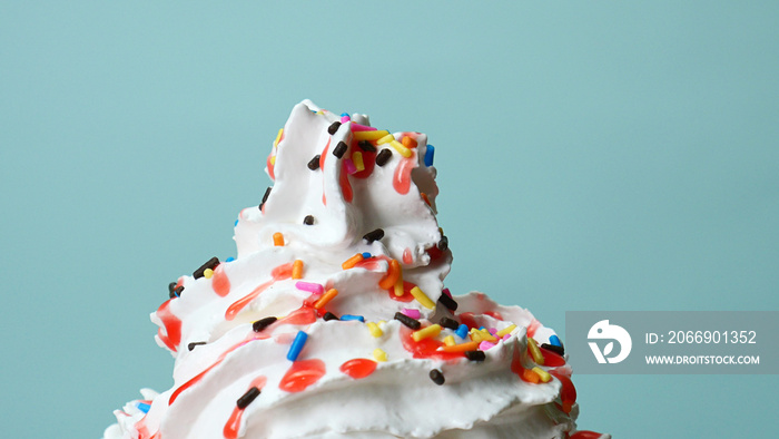 Sweet candy full many colors Whipping cream on blue background, Food concept Front view.