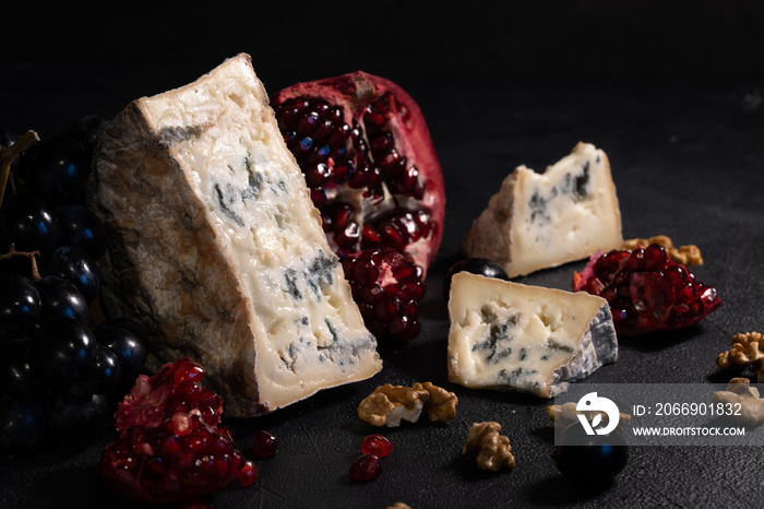 Gorgonzola blue mold cheese with pomegranate, grapes and nuts.