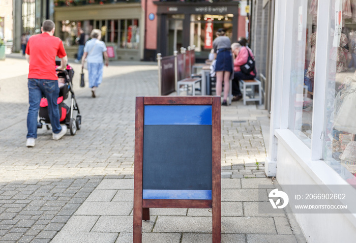 Poster placed on the floor of a pedestrian street in England