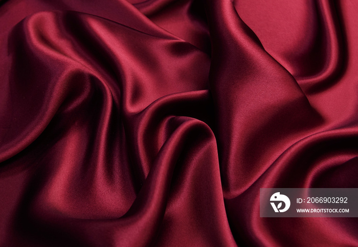 Luxurious red viscose fabric. Background and pattern.