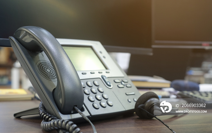 close up soft focus on telephone devices at office desk:customer service support concept:communication technology:vintage filter color tone effect.