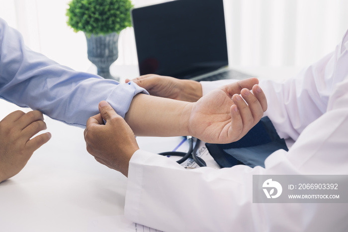 The doctor rolls up the patient’s sleeve to measure blood pressure or give an injection.