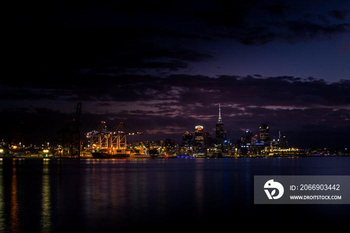 Auckland downtown at night. Dramatic view over Auckland City from North Shore