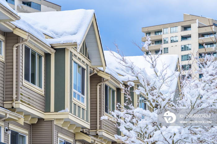 The top of a typical american home in winter. Snow covered roof and nice window.