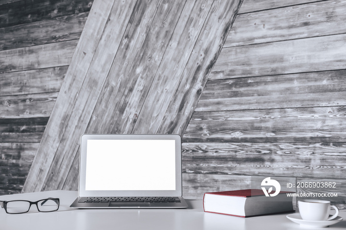 White desk with blank laptop