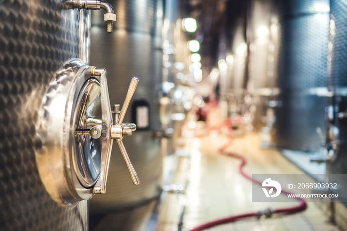 Metal vats for fermentation. Wine factory. Steel barrels in winery.