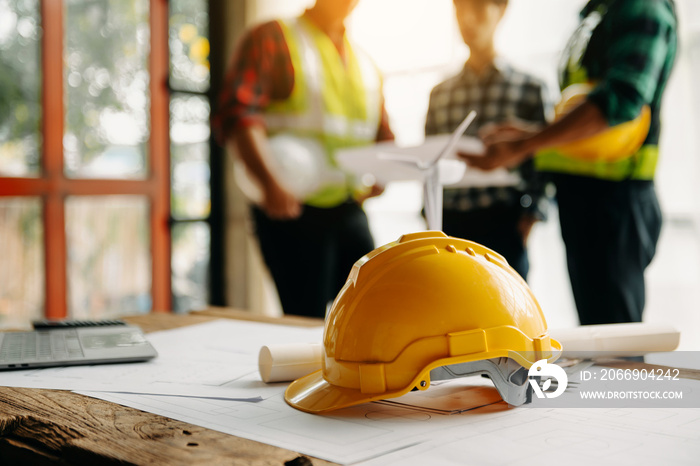 Engineer teams meeting working together wear worker helmets hardhat on construction site in modern city.Asian industry professional team.