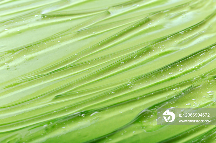 Aloe vera gel texture. Green Liquid transparent gel serum as background or gel surface. Cosmetic product for skin care or medical liquid gel.