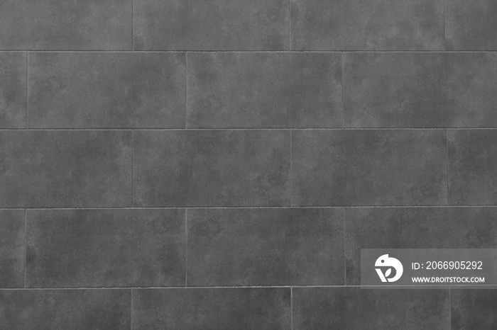 The texture of the black tile wall. Background of black tiled wall. Rectangular tile.