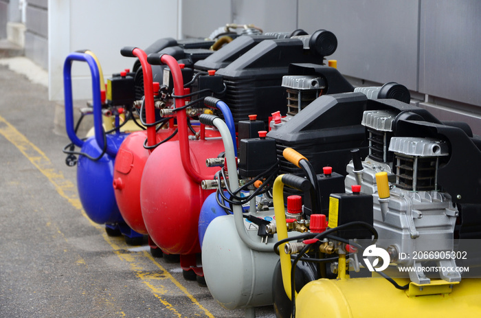 Many new air compressors pressure pumps close up photo