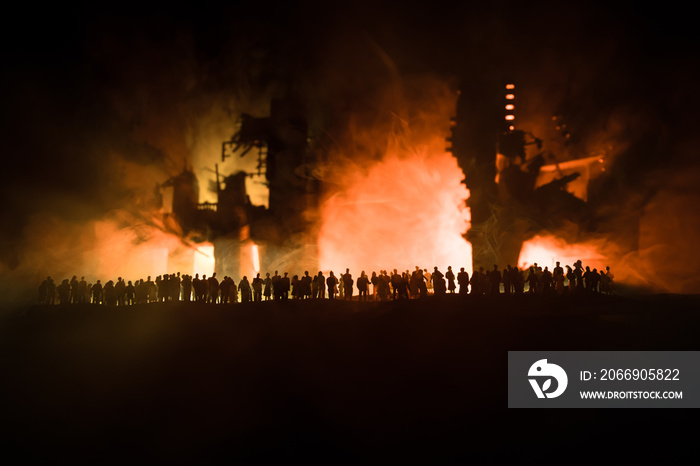 Creative artwork decoration. Chernobyl nuclear power plant at night. Layout of abandoned Chernobyl station after nuclear reactor explosion. Crowd looking on burning reactor. Selective focus