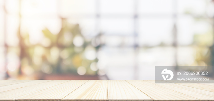 Empty wooden table top with cafe restaurant coffee shop window interior abstract blur defocused with bokeh light background for montage product display