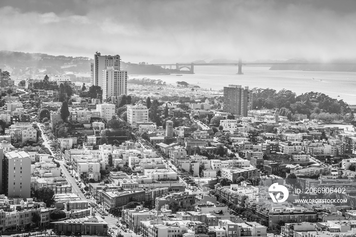 Aerial view of San Francisco skyline. Panorama black and white of the Golden Gate Bridge, Fisherman’s Wharf and North Beach from top of Coit Tower on sunny day, California, United States.