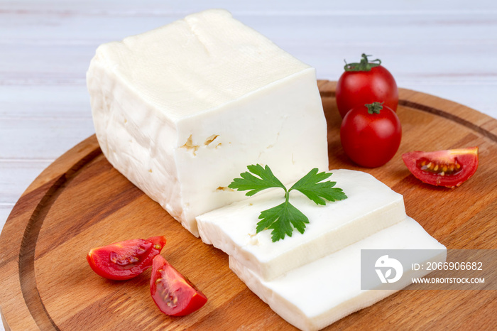 Feta greek turkish cheese on chopping board white background