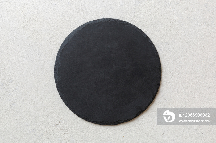 top view of empty black slate plate on cement background. Empty space for your design