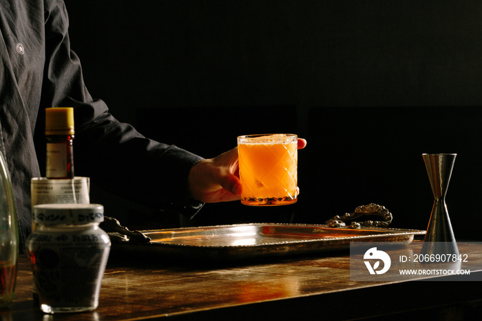 bartender hand getting a cocktail glass in a bar