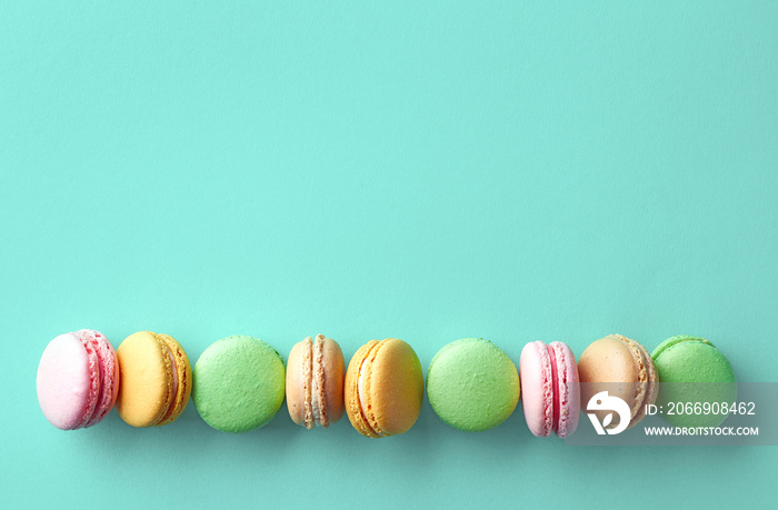 Colorful french macarons on blue background