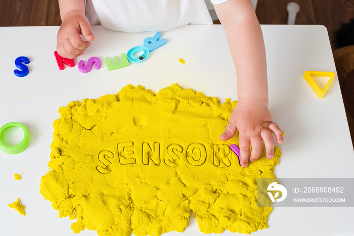 Sensory word and magic kinetic sand. Early sensory education. Kidd’s sensory experiences, games and play for fine motor skills. Therapy hand, development of fine motor, autism, occupational therapy