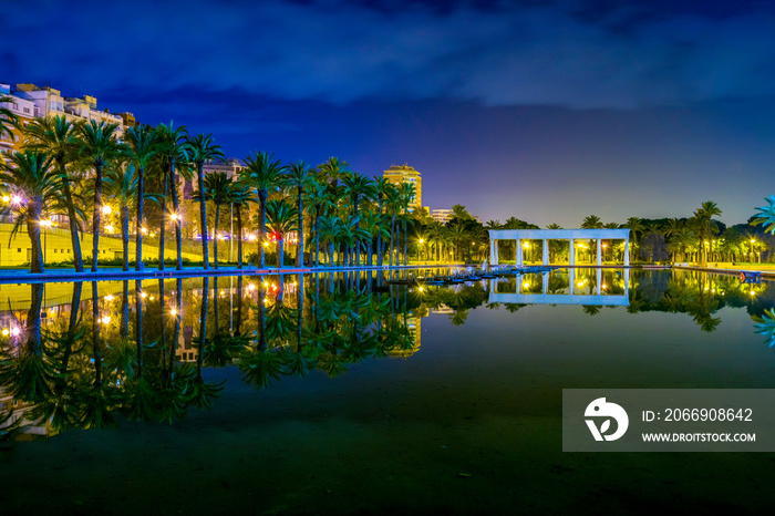 view of a pond situated in front of the palau de la musica de valencia during night