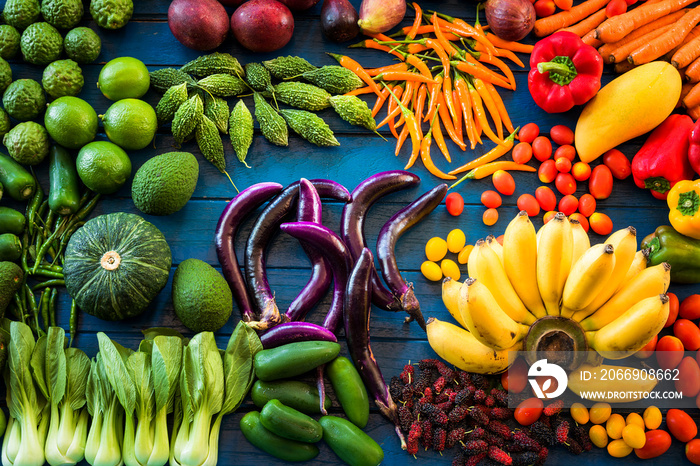 Flat lay of fresh  fruits and vegetables for background, Different fruits and vegetables for eating healthy, Colorful fruits and vegetables on blue plank