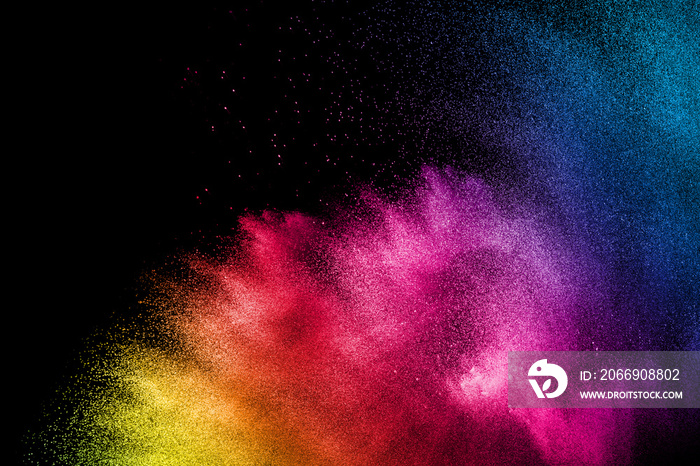 Multicolored powder explosion on black background.