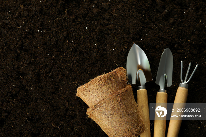 Accessories and tools for gardening on soil background