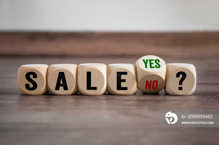 Cubes dice with Sale Yes or No on wooden background