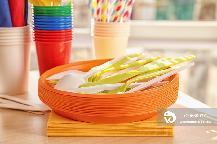 Colorful plastic ware for picnic on table