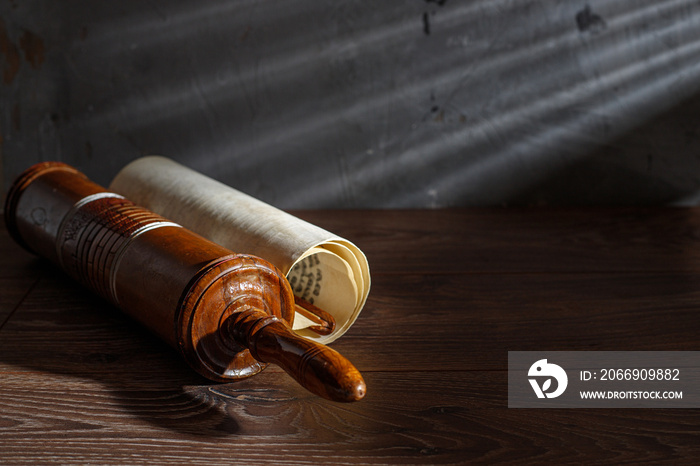 The Scroll of Esther and Purim Festival objects on a dark wooden table. Rustic.