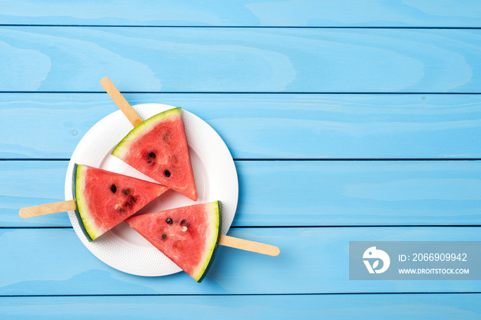 Watermelon slices on blue wooden table. Food background