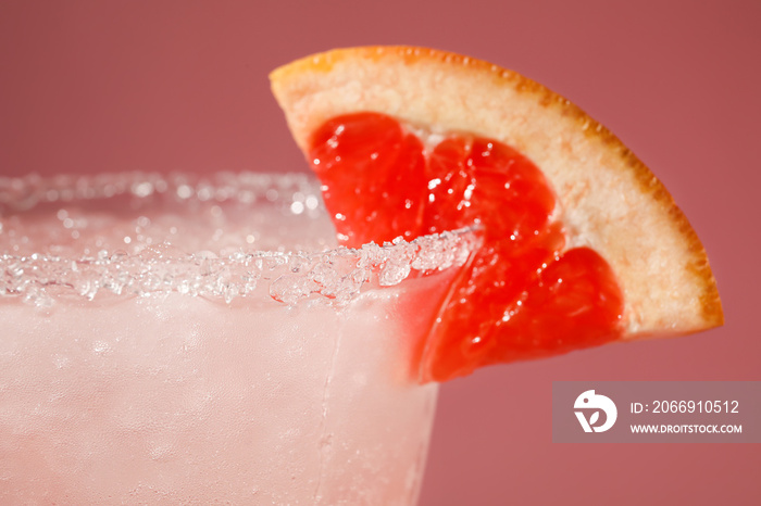 Glass of tasty grapefruit margarita on color background, closeup