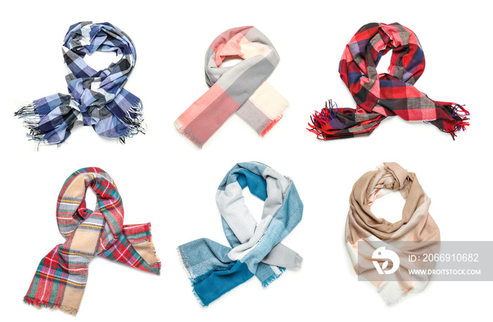 Different beautiful scarves on white background