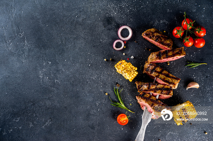 Cooking meat background. Fresh grilled meat  on dark grey table background. Top view. copy space