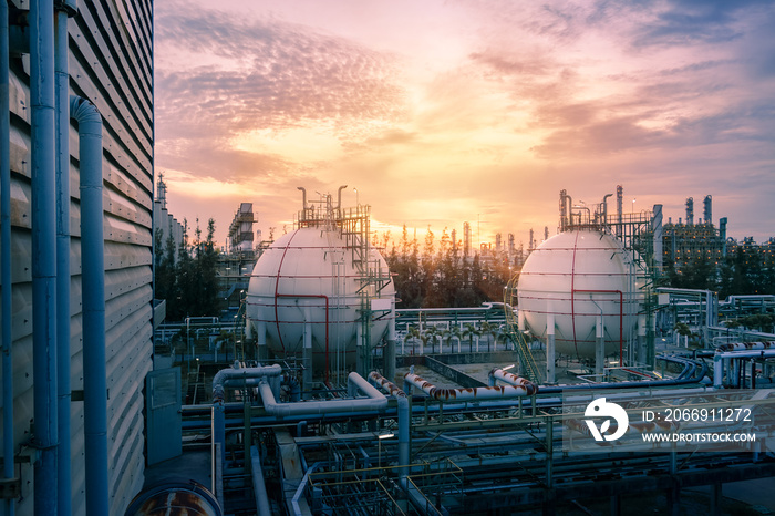 Gas storage sphere tanks and pipeline in petrochemical industrial plant on sky sunset background, Manufacturing of petroleum industry plant