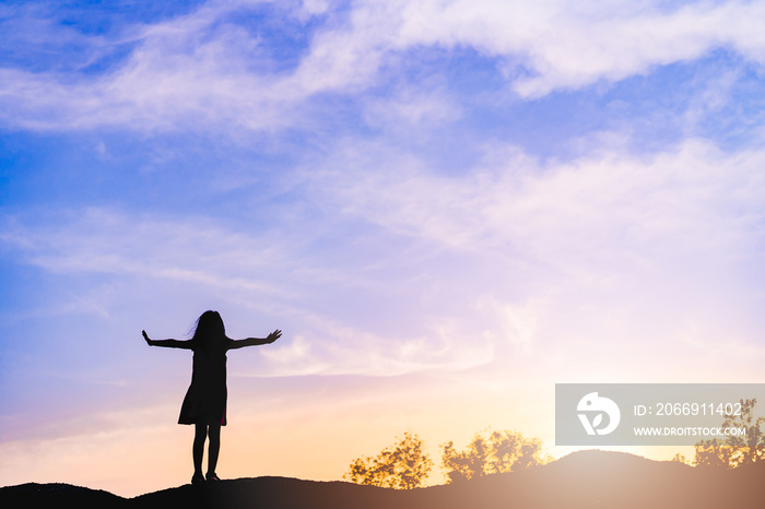 Silhouette kid pray and worship to GOD on the sunset sky.Kid child girl praying believe.Raised hands blessing worship jesus, Hope, freedom prayer.Faith,Praise, holy spirituality and religion.