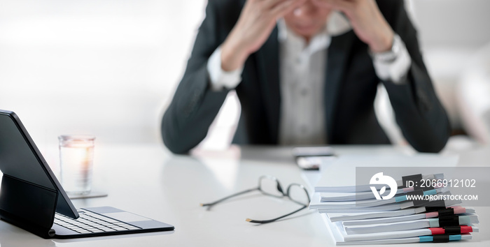 Tired, stressed businesswoman with stack of documents on the table, Occupational Stress concept.