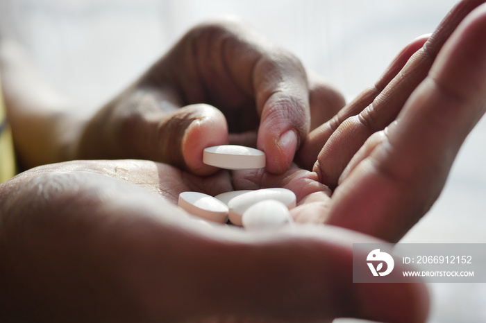 Close up of man hand holding pills with copy space